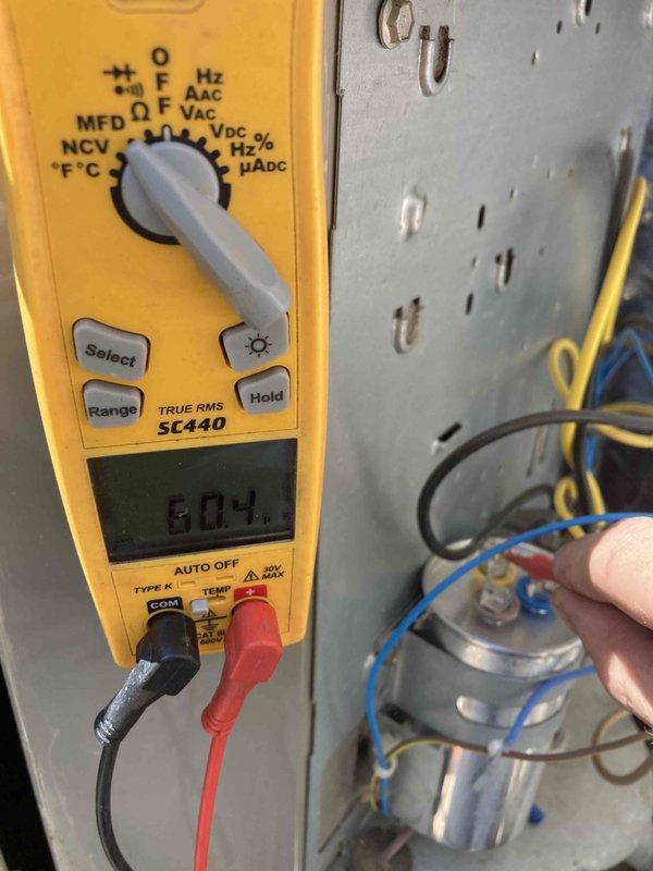 Performed cooling system tune-up and maintenance on properly functioning HVAC unit. Cleaned condenser coil to restore optimal airflow and heat transfer efficiency. Conducted comprehensive electrical diagnostics using digital multimeter, verifying capacitor functionality and measuring system amperage at 10.38A with proper voltage readings, confirming all electrical components operating within manufacturer specifications.