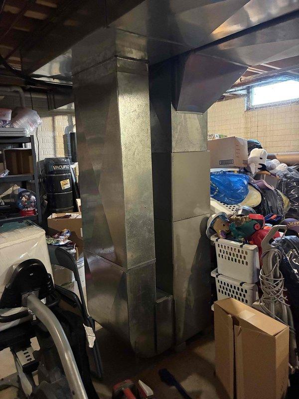 Conducted on-site assessment of existing HVAC system in residential basement for equipment replacement estimate. Evaluated current ductwork infrastructure, including main trunk line and distribution system constructed of galvanized metal with visible age-related wear and discoloration. Inspected exposed mechanical systems, air registers, and ventilation components throughout unfinished basement area. Documented existing system configuration and spatial constraints for replacement equipment sizing and installation planning. Photographed current equipment layout, ductwork routing, and basement infrastructure to support comprehensive replacement proposal for single component or complete system upgrade options.