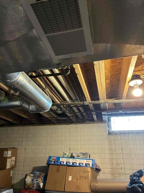 Conducted on-site assessment of existing HVAC system in residential basement for equipment replacement estimate. Evaluated current ductwork infrastructure, including main trunk line and distribution system constructed of galvanized metal with visible age-related wear and discoloration. Inspected exposed mechanical systems, air registers, and ventilation components throughout unfinished basement area. Documented existing system configuration and spatial constraints for replacement equipment sizing and installation planning. Photographed current equipment layout, ductwork routing, and basement infrastructure to support comprehensive replacement proposal for single component or complete system upgrade options.