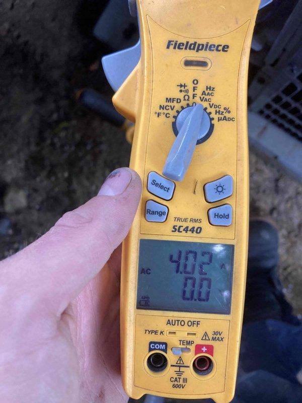 Completed prepaid air conditioner maintenance tune-up on residential AC system with no reported symptoms or issues. Performed comprehensive electrical diagnostics using digital multimeter, measuring voltage readings at control panel which displayed 4288 on initial reading and subsequent measurements of 40.3. Inspected control panel wiring connections including red, blue, yellow, white, and purple conductors to verify proper terminations and system integrity. All electrical components tested within normal operating parameters and system found to be functioning properly upon completion of preventive maintenance service.