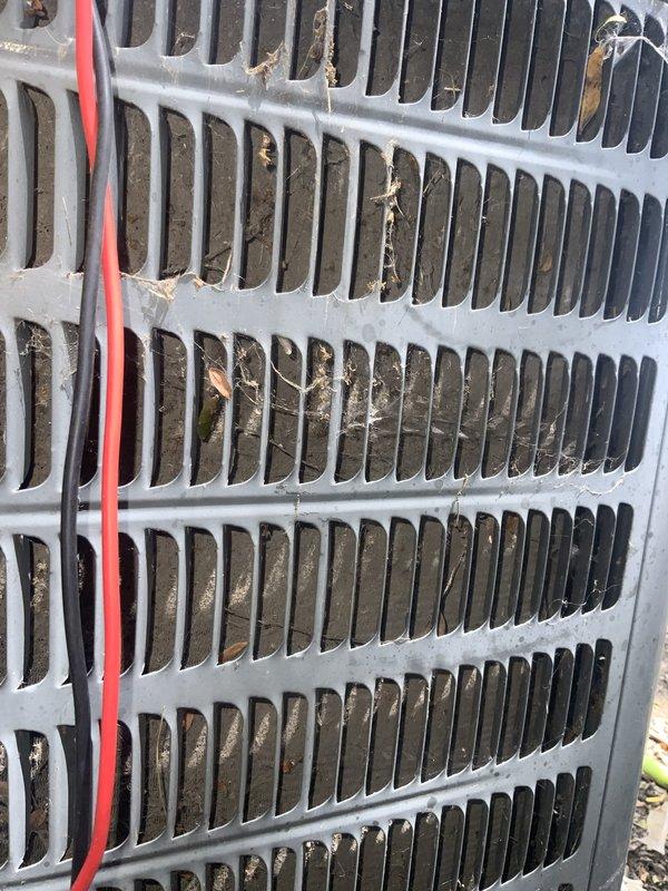 Responded to no cooling complaint on residential air conditioning system over 10 years old. Upon arrival, discovered large refrigerant line had been damaged by lawn service equipment, resulting in complete refrigerant loss. Inspected electrical disconnect box and confirmed power supply intact with all fuses operational. Examined condenser unit and noted accumulated debris on coil fins requiring cleaning. Replaced damaged refrigerant line section, pressure tested system for leaks, evacuated to proper vacuum levels, and recharged with manufacturer-specified refrigerant quantity. Cleaned condenser coil to restore proper airflow and heat transfer efficiency. System restored to normal cooling operation with proper temperatures and pressures confirmed at startup.