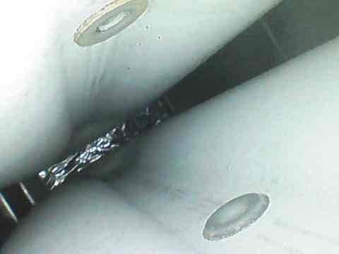 Completed routine maintenance visit for AC CLUB 8-12 agreement. Upon inspection, discovered evaporator coil completely covered in thick frost and ice buildup, indicating restricted airflow or possible refrigerant issue. Documented interior blower housing condition showing debris accumulation and iced coil assembly with crystalline formation across aluminum fins. Photographed affected components for service records and further diagnostic evaluation.