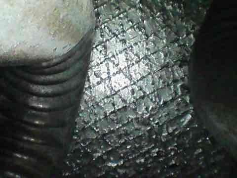 Completed preventive tune-up maintenance on residential HVAC system. Inspected evaporator coil and noted significant frost accumulation on finned surfaces, indicating potential airflow restriction or refrigerant issue. Examined ductwork and insulation in attic space, confirming proper installation and condition of insulated supply lines and flexible duct components.