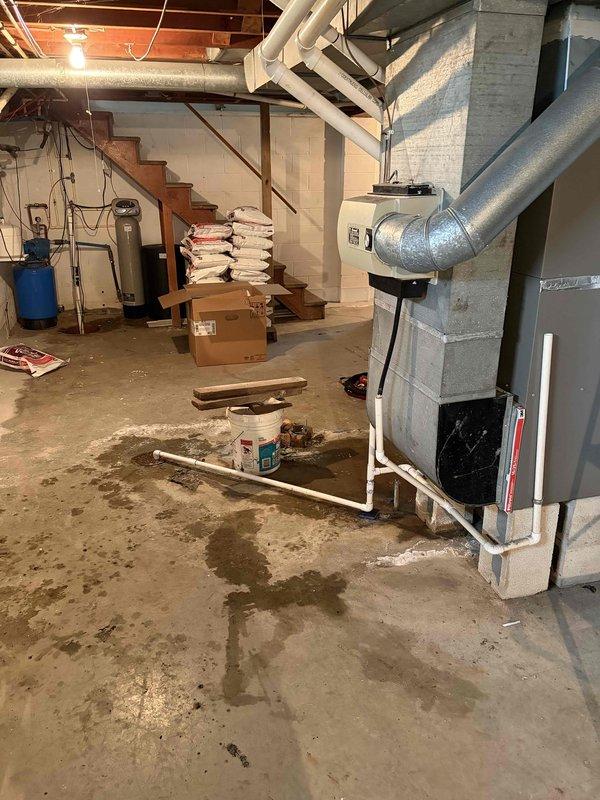 Completed installation of 2-ton air conditioning system at rear of residence, mechanical components only. Mounted outdoor condenser unit on pad against exterior wall with proper clearances, installed electrical disconnect box and associated conduit for power supply, and ran refrigerant lines with PVC drain piping to connect with existing furnace system in basement. Connected AC coil to furnace plenum, established proper refrigerant charge, verified electrical connections meet code requirements, and tested system operation to ensure proper cooling performance and airflow.