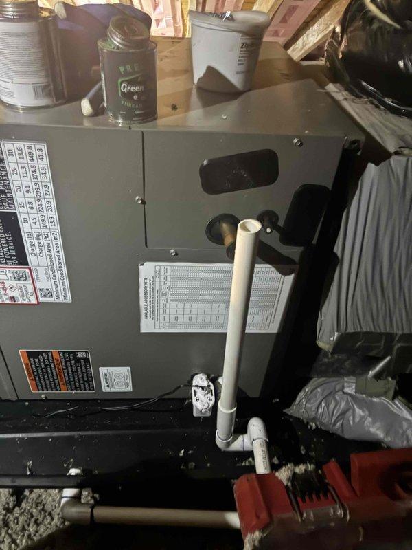 Completed installation of Lennox air handler unit in attic space with all necessary refrigerant line connections, condensate drainage system using white PVC piping, and proper integration with existing ductwork. Unit was positioned on stable platform, all electrical connections made per manufacturer specifications, system tested and verified operational with appropriate airflow.