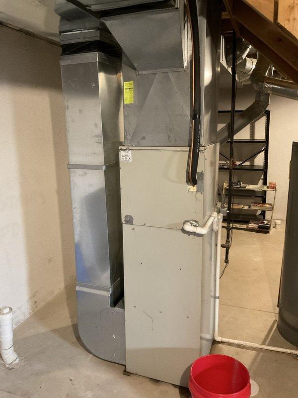 Conducted comprehensive system evaluation and discovered failed heat exchanger and frozen evaporator coil in existing furnace and air conditioning system. Documented current equipment condition with detailed photos of basement installation, including furnace cabinet, ductwork configuration, and surrounding mechanical components. Provided complete system replacement estimate to address both heating and cooling failures.