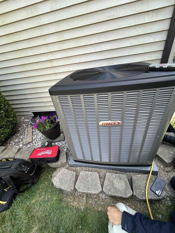 Completed warranty service on Lennox outdoor condensing unit. Uninstalled AC system, corrected and releveled concrete pad foundation, and replaced damaged exterior panels on unit casing. Unit repositioned on properly graded pad with white decorative stone surround. All panels secured and system restored to proper operating condition.