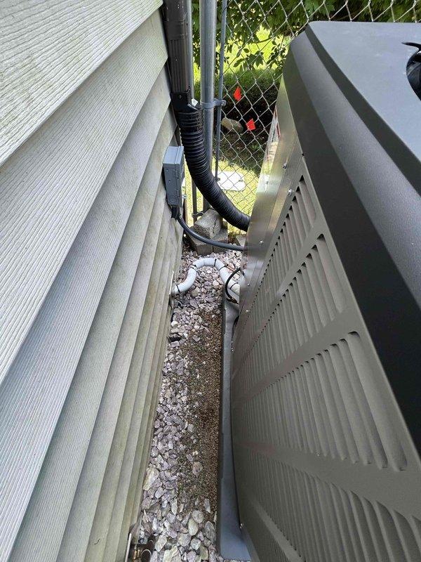 Completed warranty service on Lennox outdoor condensing unit. Uninstalled AC system, corrected and releveled concrete pad foundation, and replaced damaged exterior panels on unit casing. Unit repositioned on properly graded pad with white decorative stone surround. All panels secured and system restored to proper operating condition.