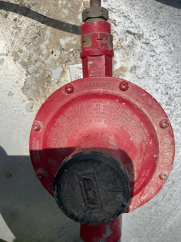 Conducted on-site evaluation for new whole home generator installation at manufactured home. Assessed existing gas service infrastructure, including red gas regulator valve and gas line routing along exterior wall. Documented current utility connections and identified optimal placement for generator unit, considering gas line accessibility and electrical service panel proximity. Noted existing infrastructure conditions including weathered exterior surfaces and aged gas piping with visible corrosion requiring consideration for safe generator integration.