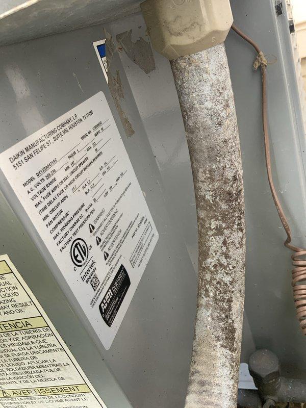 Responded to no cooling call on 5-year-old Daikin system that completely stopped operating following previous service visit. Upon inspection, found severe corrosion and deterioration on refrigerant line insulation within air handler cabinet, indicating possible refrigerant leak or moisture intrusion issue. Examined outdoor unit electrical components including capacitor and contactor, verifying proper wiring connections and component integrity. Documented extensive white powdery corrosion buildup on suction line, suggesting long-term exposure to moisture or chemical reaction that may have contributed to system failure. Due to repetitive nature of failure and severity of component deterioration observed, recommended comprehensive system evaluation to identify root cause of recurring issues before proceeding with repairs.