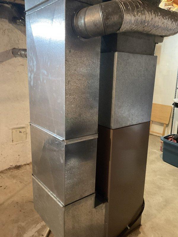 Completed HVAC system estimate for replacement of 30-year-old residential air conditioning and heating system. Current furnace operational but air conditioning unit non-functional. Assessed outdoor condenser unit on concrete pad showing significant weathering and age-related deterioration, along with basement furnace and ductwork system utilizing natural gas fuel source.