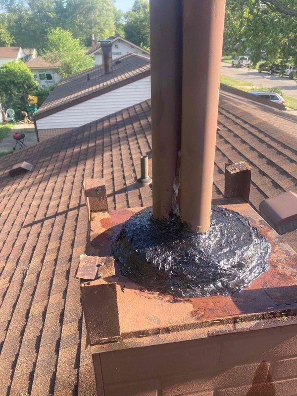 Responded to callback for water heater venting leak. Upon inspection, identified compromised weatherproofing at vent pipe penetration on metal roof panel, with significant rust and corrosion present on flashing. Documented deteriorated sealant and flashing conditions at both the metal roof penetration point and secondary vent stack location on shingled roof section, where aged roofing tar and rusted flashing were contributing to water infiltration at venting assembly.