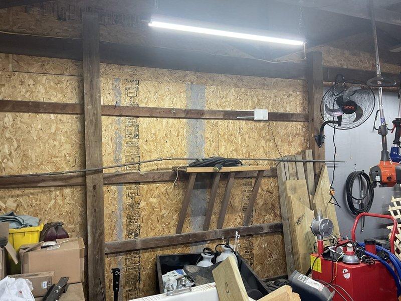 Conducted on-site assessment for mini split installation in garage workshop space with OSB wall construction and exposed wooden framing. Evaluated electrical infrastructure including existing breaker panel with available circuit capacity and determined optimal equipment placement considering workspace layout and existing mechanical systems. Documented installation location requirements and electrical service compatibility for proposed mini split system.