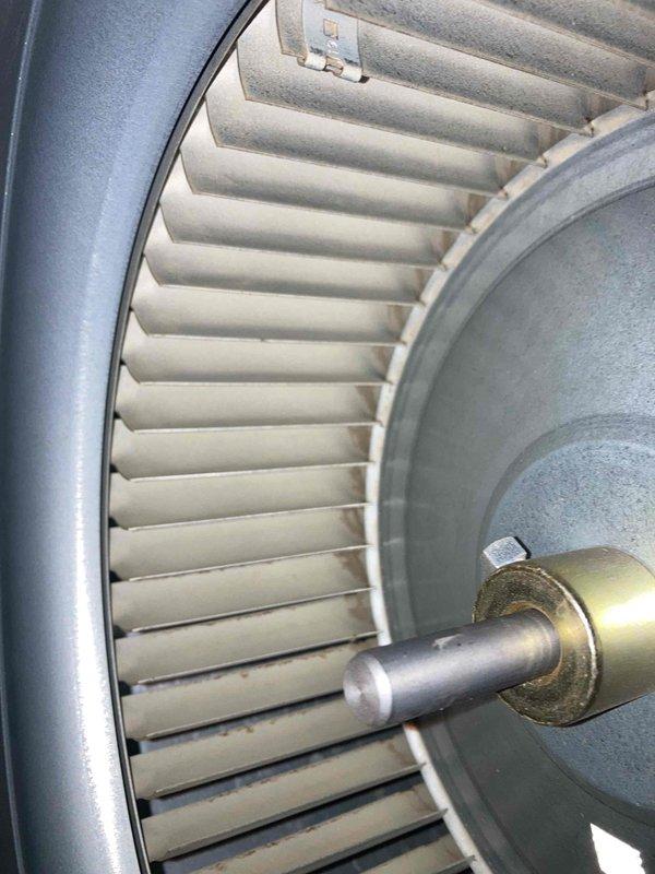 Completed annual AC maintenance and tune-up on residential air conditioning system. Performed comprehensive inspection of indoor air handler unit including blower wheel assembly, which showed clean condition with properly functioning squirrel cage fan and intact blades. Verified blower motor shaft, collar, and mounting components operating correctly with no signs of wear or misalignment. Inspected condensate drainage system including drain pan, condensate pump with visible intake ports, and associated PVC discharge piping with proper routing and elbow configurations. Confirmed electrical connections secure on condensate pump. Checked refrigerant lines with insulation properly secured. All system components found in good working order with no deficiencies noted. System operating within normal parameters.