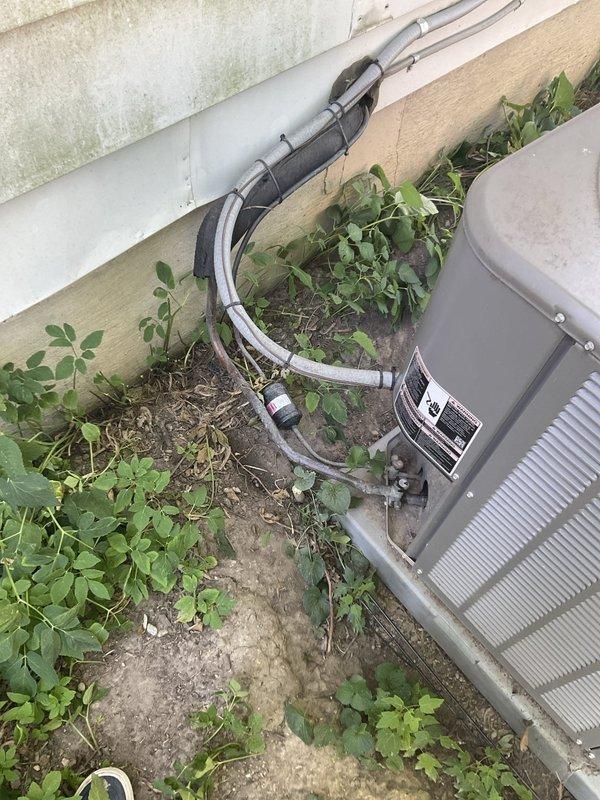 Responded to no-cooling complaint on 2-year-old Lennox AC system. Upon arrival, confirmed unit would not power on. Inspected low-voltage thermostat wiring and discovered damaged control wire between indoor air handler and outdoor condensing unit—wire insulation chewed through by rodents, causing open circuit. Repaired damaged section of thermostat wire, restored proper connections, and verified 24VAC signal at contactor. Tested system operation; unit powered on successfully with compressor and condenser fan running normally. Confirmed proper cooling cycle and advised customer on potential pest prevention measures to protect wiring.