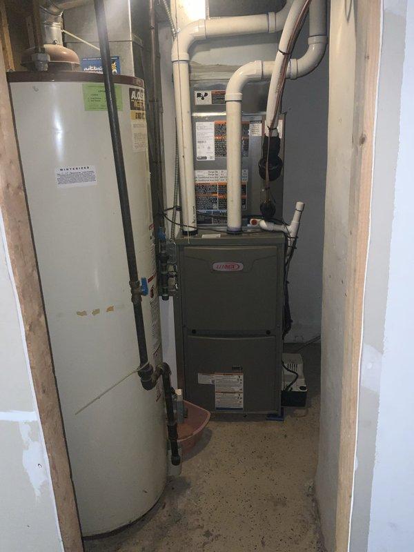Completed scheduled preventive maintenance agreement visit on residential HVAC system including Lennox furnace and air conditioning components. Performed comprehensive tune-up inspection of heating and cooling equipment located in basement mechanical room. Inspected furnace operation, verified proper function of all safety controls, and checked gas connections and venting system. Examined air filter condition and found moderate dust accumulation on pleated media filter. Evaluated water heater installation and surrounding mechanical systems for any potential concerns. Verified all PVC ductwork and piping connections were secure with no visible leaks or damage. System operating within normal parameters with no deficiencies noted at time of service.