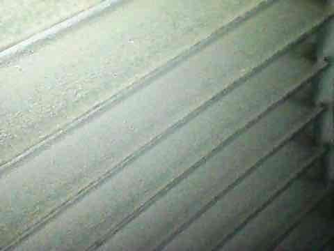 Completed preventive maintenance inspection under CLUB AC 12-4 agreement. Condenser coil exhibited significant buildup of white crystalline deposits and debris accumulation between fins, restricting airflow and reducing heat transfer efficiency. Thoroughly cleaned and treated condenser coil to restore proper operation. Inspected ductwork components showing normal wear patterns with minor dust accumulation on corrugated surfaces.