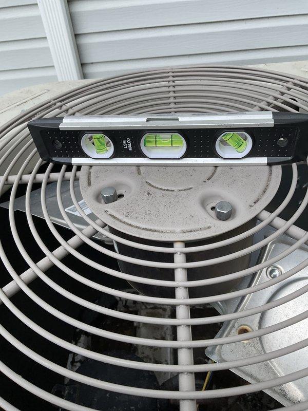 Responded to no-cool complaint where AC unit was running constantly but struggling to maintain temperature throughout the home. Upon arrival, performed comprehensive system evaluation and found outdoor condenser unit significantly out of level, which can cause compressor oil migration issues and reduced cooling efficiency. Used precision level to verify unit was not properly positioned on pad, then releveled condenser unit to manufacturer specifications to ensure proper refrigerant flow and compressor lubrication. Verified unit operation after leveling correction.