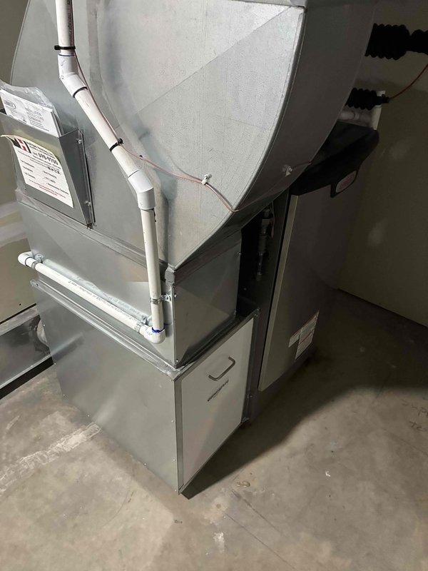 Completed full HVAC system installation including 110,000 BTU furnace, 4-ton air conditioning unit with rear discharge configuration, and humidifier. Installed all associated condensate drainage lines using PVC piping with proper pitch and routing, mounted condensate pump for proper drainage management, and configured all necessary electrical connections and control wiring. Reconnected existing ductwork to new equipment and verified all mechanical connections for proper system operation.