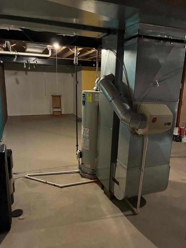 Conducted comprehensive HVAC system evaluation on aging R22 residential system with multiple component failures. Diagnosed failing condenser fan motor and blower capacitor reading out of acceptable range, both requiring immediate replacement. Due to obsolete R22 refrigerant and age of existing equipment, provided detailed estimate for both individual component repairs and complete system replacement options. Documented current system configuration including furnace, ductwork, and mechanical room layout with photographic evidence for customer reference and proposal development.