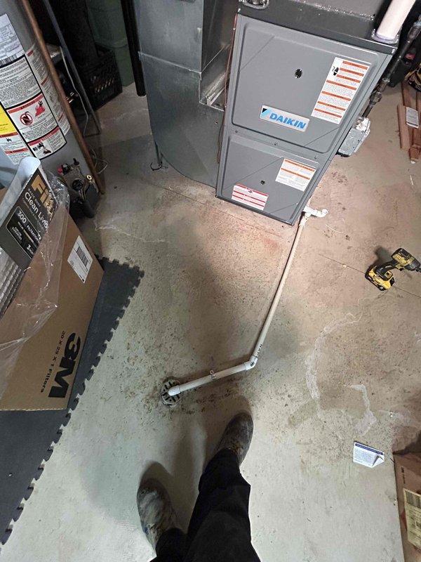 Successfully installed a new 3-ton Daikin air conditioning system with matching evaporator coil in the basement utility area. The installation included proper refrigerant line connections, electrical hookup, condensate drainage via PVC piping, and reconnection of all ductwork to the existing air handler. All mechanical and electrical components were installed to manufacturer specifications and tested for proper operation.