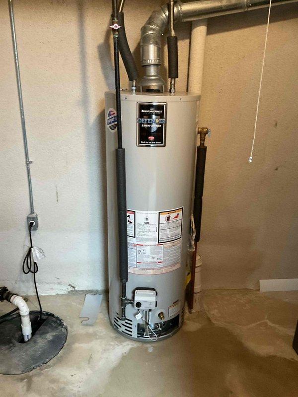 Responded to callback for reported water leak initially suspected to be from another source. Upon inspection, identified active water heater as leak source with visible moisture accumulation at base of unit on concrete floor. Documented water heater installation including all plumbing connections, copper supply lines with shut-off valves, metallic exhaust venting, and surrounding utility area components. Verified leak originating from water heater tank, confirmed with photographic evidence showing wet conditions at floor level around unit base. Notified customer of findings and recommended appropriate corrective action for water heater replacement.