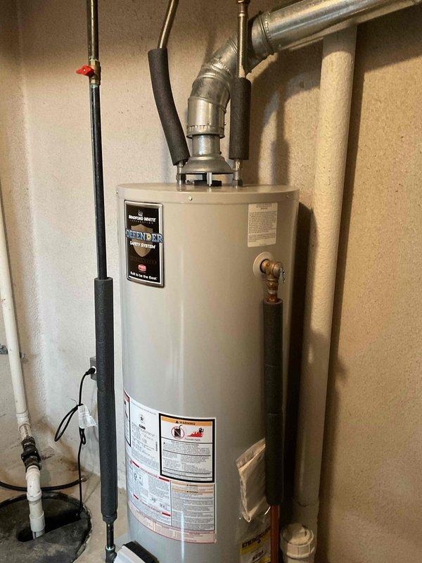 Responded to callback for reported water leak initially suspected to be from another source. Upon inspection, identified active water heater as leak source with visible moisture accumulation at base of unit on concrete floor. Documented water heater installation including all plumbing connections, copper supply lines with shut-off valves, metallic exhaust venting, and surrounding utility area components. Verified leak originating from water heater tank, confirmed with photographic evidence showing wet conditions at floor level around unit base. Notified customer of findings and recommended appropriate corrective action for water heater replacement.