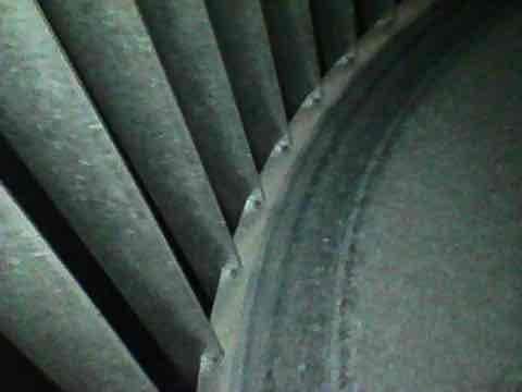 Responded to no-cooling call where unit would not turn on and made clicking sound when attempting to start. Upon inspection, accessed air handler through basement stairwell and examined blower assembly. Found blower wheel heavily coated with dust and debris accumulation, restricting airflow and likely causing system safety lockout. Cleaned blower wheel and housing, verified proper motor operation, and restored unit to normal cooling function.