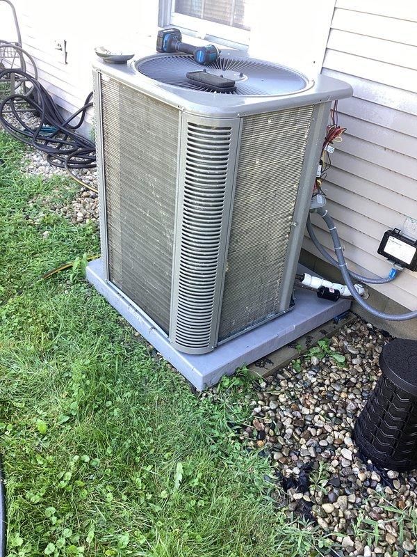 Completed preventive maintenance agreement visit on residential AC system under Club AC8-12 plan. Performed comprehensive inspection of outdoor condenser unit, including visual assessment of cabinet condition, refrigerant line connections, and electrical components. Unit showed normal age-related weathering but remained operational. Documented equipment condition with photographs for service records.