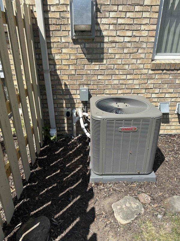 Completed full HVAC system installation including 90,000 BTU furnace, humidifier, and 2.5-ton Lennox air conditioning condenser unit. Installed furnace in basement mechanical room with proper metallic ductwork connections and venting. Positioned outdoor condenser unit on concrete pad against rear exterior brick wall with appropriate electrical conduit and PVC piping connections. Reconnected all electrical and mechanical components per code requirements. System tested and operational upon completion.