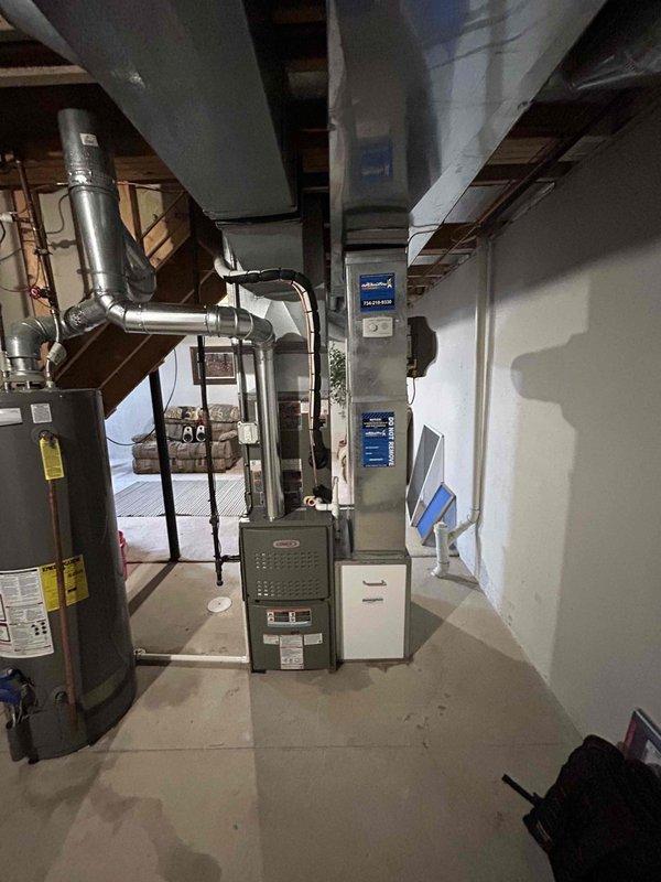 Completed full HVAC system installation including 90,000 BTU furnace, humidifier, and 2.5-ton Lennox air conditioning condenser unit. Installed furnace in basement mechanical room with proper metallic ductwork connections and venting. Positioned outdoor condenser unit on concrete pad against rear exterior brick wall with appropriate electrical conduit and PVC piping connections. Reconnected all electrical and mechanical components per code requirements. System tested and operational upon completion.