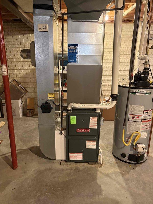 Successfully completed installation of a 3.5-ton air conditioning system with matching evaporator coil in the rear yard location. The mechanical-only installation included reconnection of all necessary components, with the indoor coil integrated into the existing Goodman furnace system in the basement utility area.