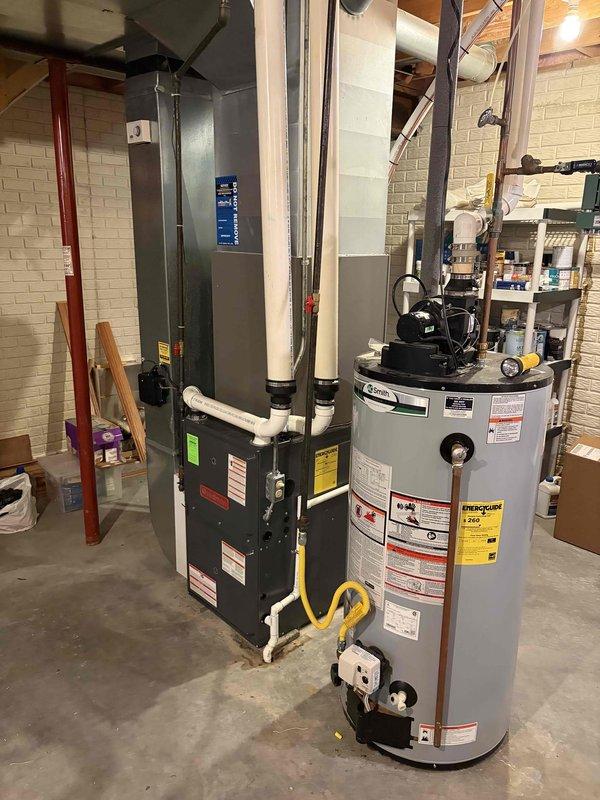 Successfully completed installation of a 3.5-ton air conditioning system with matching evaporator coil in the rear yard location. The mechanical-only installation included reconnection of all necessary components, with the indoor coil integrated into the existing Goodman furnace system in the basement utility area.