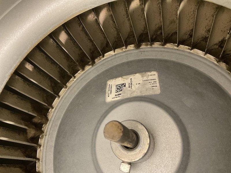 Completed preventative maintenance inspection on residential HVAC system as part of club agreement service. Documented condition of blower wheel assembly showing moderate dust accumulation on blades and discoloration around hub connections, and inspected internal furnace components including burner assembly, gas valve, copper refrigerant lines with visible patina, control board, and wiring harnesses, with all systems found operational and photographic documentation captured for service records.
