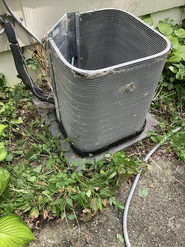 Completed preventive maintenance agreement visit for residential air conditioning system. Performed comprehensive inspection of both indoor furnace unit and outdoor condenser, documenting equipment specifications and current operating conditions. Outdoor condenser unit showed signs of environmental exposure with vegetation encroachment requiring clearance for proper airflow, and exterior surfaces displayed weathering consistent with normal outdoor operation. Documented manufacturer specifications from furnace nameplate including model KG7SC 0540-24B for service records. System components including electrical connections, refrigerant lines, and condenser coils were visually inspected as part of routine maintenance protocol.