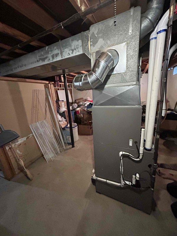 Completed full HVAC system installation in basement location, replacing existing equipment with new 70,000 BTU furnace and 2-ton air conditioning system. Performed all mechanical and electrical connections per manufacturer specifications and local code requirements. Installed new chimney liner to ensure proper venting for combustion appliance. Integrated whole-home humidifier into ductwork for indoor air quality enhancement. Routed refrigerant lines and condensate drainage to rear yard for outdoor condenser unit placement. Reconnected all ductwork, electrical circuits, and gas supply lines. Verified proper system operation, airflow, and safety controls upon completion. Unit tested and left in operational condition.