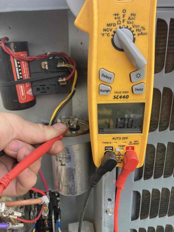 Completed scheduled preventative maintenance and tune-up on residential air conditioning system. Performed comprehensive system inspection including electrical testing of capacitor using digital multimeter, verified proper voltage readings, and inspected contactor and relay components. Inspected condenser coil condition and outdoor disconnect box with visible LED indicator confirming proper operation. System operating within normal parameters with no issues identified during routine maintenance visit.