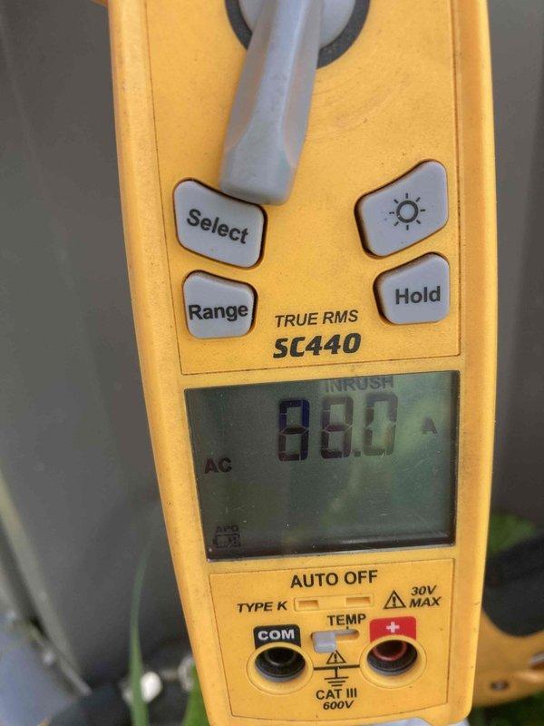 Completed prepaid annual air conditioner tune-up maintenance on outdoor AC unit. Performed comprehensive system inspection including electrical measurements using digital clamp meter, recording 880 AC amperage reading to verify proper compressor operation. Inspected indoor components including condensate pump system and drainage lines with PVC piping and fittings, confirming proper operation and drainage flow. All system parameters found within normal operating specifications with no issues identified during maintenance visit.
