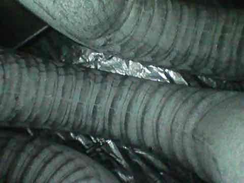 # Emergency Furnace Blower Noise Diagnosis

Responded to emergency service call for loud noises coming from furnace blower on a thirteen-year-old system. Upon arrival, verified unit was still operational and providing cooling. Conducted thorough inspection of blower assembly, motor bearings, and blower wheel for signs of wear, debris accumulation, or mechanical failure. Examined flexible ductwork connections and transitions in mechanical space for potential vibration issues or loose components that could contribute to noise transmission. Inspected metallic sealing tape and duct connections for integrity. Documented existing condition of HVAC ductwork system and blower assembly with photos showing flexible duct installation and component arrangement. Provided diagnosis of noise source and recommendations for repair or replacement given age of system and recent maintenance history.