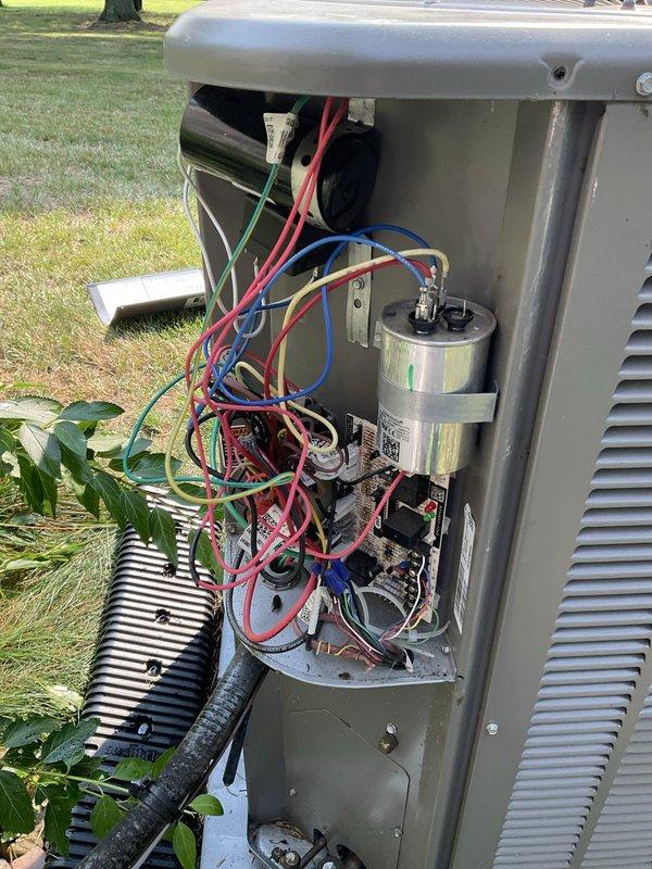 Completed scheduled air conditioning tune-up and preventive maintenance on residential outdoor condensing unit. Performed comprehensive system inspection including electrical connections, capacitor testing, and refrigerant circuit evaluation. Accessed internal components to verify proper operation of contactor, capacitor, and control board connections. Exterior unit showed significant dirt accumulation and weathering; cleaned condenser coils and housing to restore optimal airflow and heat transfer efficiency. All electrical connections verified secure with proper color-coded wiring intact. System tested and confirmed operational within normal parameters upon completion of maintenance protocol.
