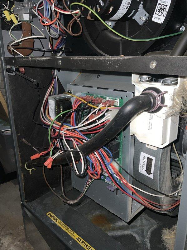 Responded to no-cool call on 5-year-old air conditioning system previously installed by our company. Upon arrival, confirmed unit would not start and provided no cooling to the residence. Performed diagnostic inspection of outdoor condensing unit and indoor air handler components. Inspected electrical connections at outdoor unit contactor assembly, noting multiple wire terminations and connection integrity. Examined indoor control board, blower motor assembly, and associated wiring harnesses for proper operation and secure connections. Documented system conditions with photographs showing electrical terminal block connections and internal air handler components including control board with multi-colored wire connections, blower motor, and condensate management system. Completed check-with-owner-watching (CWOW) protocol, reviewing findings and system status with homeowner present throughout diagnostic process.