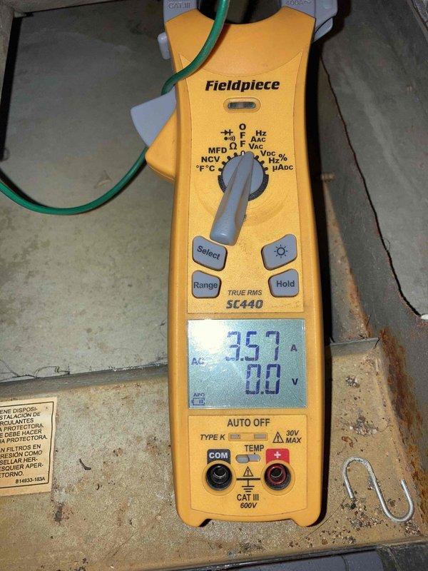 Completed comprehensive cooling system tune-up on residential HVAC unit located in basement. Performed full system inspection including refrigerant level verification, temperature split measurements, and electrical diagnostics with clamp meter showing 35.7 amp draw. System operating properly with all parameters within normal specifications.