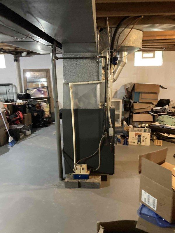 Completed comprehensive cooling system tune-up on residential HVAC unit located in basement. Performed full system inspection including refrigerant level verification, temperature split measurements, and electrical diagnostics with clamp meter showing 35.7 amp draw. System operating properly with all parameters within normal specifications.