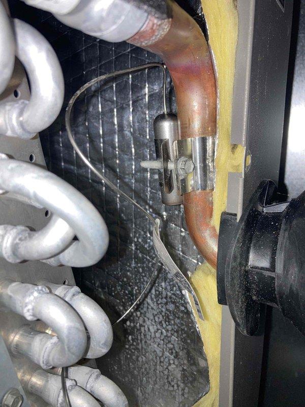Completed prepaid AC tune-up on residential air conditioning system. Performed comprehensive maintenance including electrical diagnostics with multimeter showing 24.18V reading at control circuit, inspected refrigerant lines and copper piping connections, and examined condenser coil and internal components. All systems operating within normal parameters with no deficiencies noted.