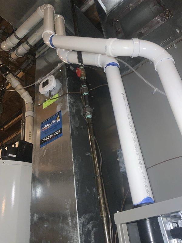 Completed comprehensive tune-up and inspection on both air conditioning and furnace systems as part of seasonal maintenance service. Inspected blower assembly, verified proper operation of fan motor and blade configuration, and examined overhead mechanical installations including PVC drainage lines and air handler unit. All components found to be in satisfactory working condition with no immediate repairs required.