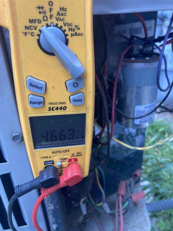Completed preventive maintenance tune-up on HVAC system. Performed electrical diagnostics using digital multimeter, recording voltage readings at 118.7V and inspecting capacitor connections and wiring. Inspected furnace burner assembly and igniter component, noting normal operational wear with minor surface oxidation on burner chamber and mounting hardware.
