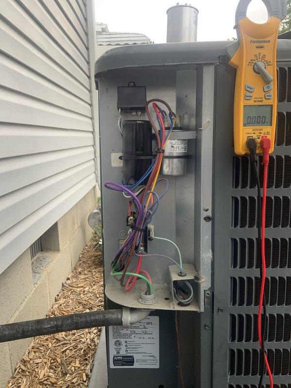 Completed seasonal AC maintenance inspection as part of club membership agreement. Performed electrical diagnostics on outdoor condensing unit, measuring voltage and amperage at the electrical compartment with digital multimeter to verify proper system operation. Inspected control board, capacitor, wiring connections, and all internal components for wear or damage, finding all systems operating within normal parameters.