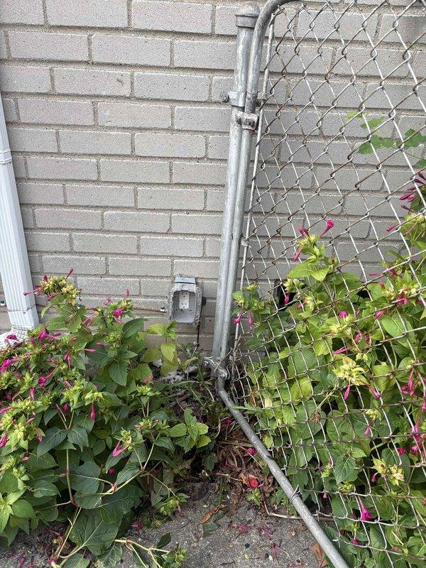 Installed ground fault circuit interrupter (GFI) protection at exterior location near brick wall and chain-link fence boundary. Accessed main electrical panel in attic space, identified appropriate circuit for outdoor receptacle, and configured GFI breaker to provide required ground fault protection for exterior outlet. Verified proper operation of GFI device and confirmed circuit integrity upon completion.
