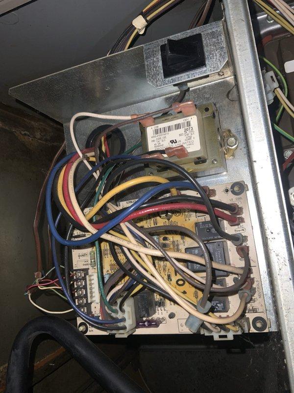 Responded to no-cool complaint with air conditioning system blowing warm air throughout the residence. Upon inspection, found outdoor condensing unit with significant accumulation of dirt, debris, and organic material in cabinet and on internal components, including capacitor and contactor assembly. Examined electrical connections and control panel wiring, noting system showed signs of age and environmental exposure with visible weathering on metal surfaces. Documented condition of unit interior, electrical components, and control board with multiple wire connections. Unit components including cylindrical capacitor and black contactor relay were assessed for proper operation and connection integrity.