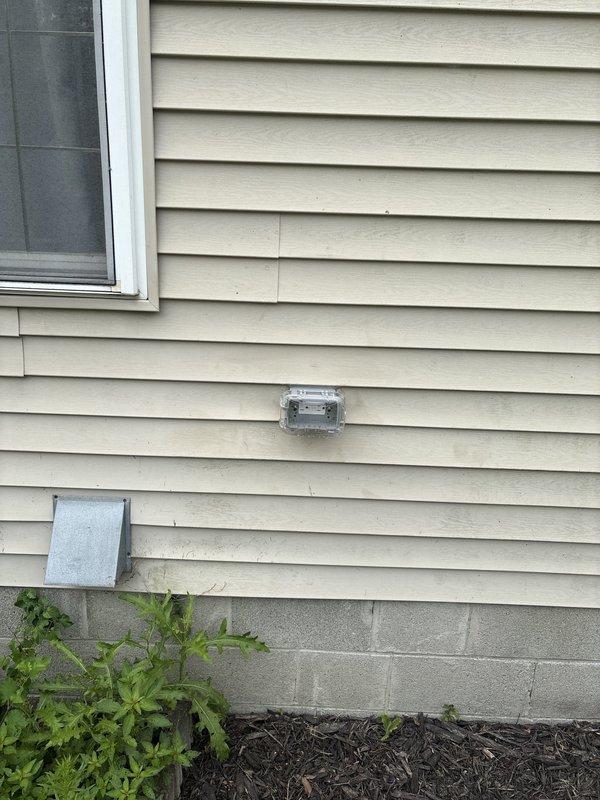 Installed a GFCI-protected exterior electrical outlet on the side of the residence. The new weatherproof receptacle was mounted to the vinyl siding with appropriate exterior-rated cover and box, providing ground fault circuit interruption protection for outdoor electrical use in compliance with current electrical codes.